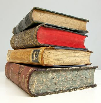 A stack of four antique leather-bound books